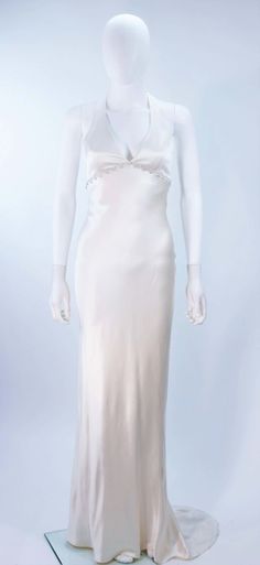 For Sale on 1stDibs - This Monique Lhuillier gown is composed of a white bias cut silk and features a rhinestone applique at the empire waistline. There is a center back zipper Glamorous Silk Evening Dress For Wedding, Silk Wedding Dress With Fitted Bodice For Evening, Silk Floor-length Wedding Dress For Wedding Night, Floor-length Silk Wedding Dress For Wedding Night, Silk Floor-length Wedding Dress, Wedding Evening Dress With Bias Cut, Elegant Silk Gown For Debutante Ball, Formal Silk Wedding Dress With Fitted Bodice, Wedding Satin Evening Dress, Bias Cut