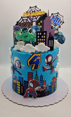 a birthday cake decorated with spiderman and other cartoon characters