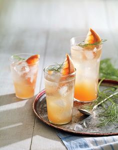 two glasses filled with drinks sitting on top of a table