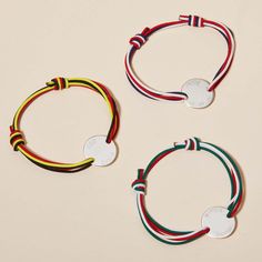 Our Men's Personalized Olympic Bracelet is a fun way to represent a country in bracelet form. Choose three colorful braid colors to represent your flag and pair with a hand-engraved disc. Add names, dates, and words for an extra-special touch to this unique bracelet.&nbsp;925 Sterling SilverCharm: 0.8”x0.8”Braid made of durable, colorfast polyesterSize: between 8-9, fully adjustable sliding knot fasteningEngraved by hand in our Paris workshopSent with love in a complimentary gift boxAny slight variations in lettering depth, spacing and alignment from the examples shown are part of the aesthetic and originality of the piece Crystal Dice, Grandmother Gifts, Engraved Bracelet, Crystal Stars, Sliding Knot, Unique Bracelets, Gifts For New Moms, Hand Engraving, Ring Bracelet