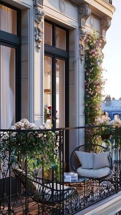 a balcony with wrought iron railings and potted plants on the balconies