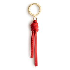 a red leather keychain with a gold metal ring on it's end