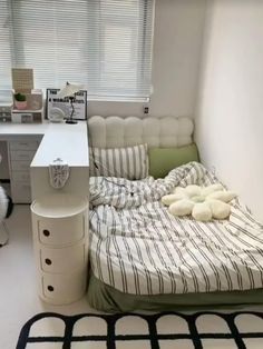 a small bedroom with a bed and desk