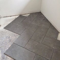 a bathroom floor that is being remodeled with tile on the floor and in between the walls