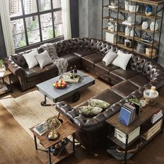 a living room filled with lots of brown furniture and decor on top of a hard wood floor