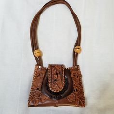 "Great bag, great condition! Never used, new! 8.5\" wide x 6.5\" high x 2\" leather hand tooled Zaria label on front Wooden beads" Leather Bags With Concho For Everyday Use, Bohemian Leather Bag With Concho, Vintage Brown Hand Tooled Satchel For Daily Use, Western Style Brown Bag With Concho, Bohemian Brown Bags With Concho, Vintage Brown Hand Tooled Crossbody Shoulder Bag, Vintage Brown Hand-tooled Crossbody Shoulder Bag, Vintage Brown Hand Tooled Rectangular Shoulder Bag, Vintage Brown Rectangular Hand Tooled Shoulder Bag