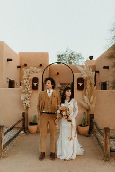 a man and woman standing in front of a building