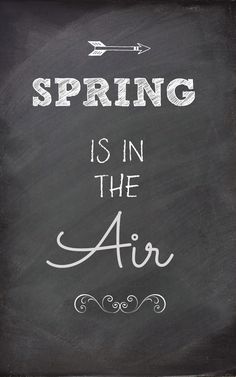 a chalkboard with the words spring is in the air written on it and an arrow