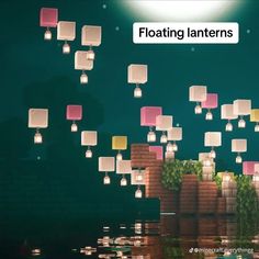 floating lanterns in the air above water at night