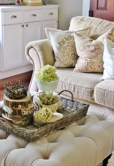 a living room filled with lots of furniture and flowers on top of a coffee table