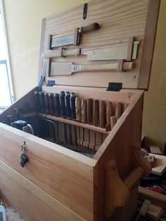 a large wooden box filled with lots of tools