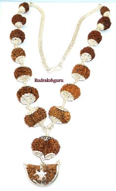 "Product Name : Rudraksha Siddha Mala - Nepal Design : All the Rudraksha are Strung In silver wire having knot style , With Silver Cap on each beads and finally attach With strong silver chain . Configration : 1 mukhi Rudraksha - Half moon Shape , Dimension : 35 mm - 36 mm 2 mukhi , 3 mukhi Rudraksha - Dimension : 20 mm - 21 mm 4 mukhi , 5 mukhi , 6 mukhi , 7 mukhi , 8 mukhi , 9 mukhi , 10 mukhi , Ganesh Rudraksha - Dimension : 22 mm - 24 mm 11 mukhi , 12 mukhi , 13 Mukhi , 14 Mukhi - Dimension Navratri Puja Cutdana Mala, Festival Rituals Mala With Cutdana, Cutdana Mala For Rituals And Festivals, Diwali Rituals Mala With Pallu, Festive Rituals Mala With Pallu, Gauri Shankar, Barbie Song, All Mantra, Low Self Worth