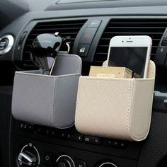 the cell phone holder is attached to the dashboard of a car with other items in it