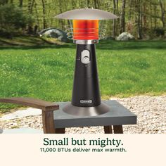 an advertisement for a small but mighty heater on a picnic table in the woods