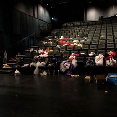 stuffed animals are sitting in the middle of an empty auditorium