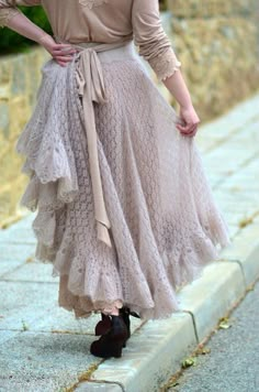 a woman is standing on the steps wearing a skirt and heels with her hands on her hips