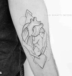 a black and white photo of a heart tattoo on the right arm with geometric shapes around it