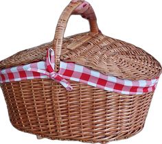 a wicker basket with a red and white checkered ribbon tied around the handle