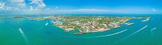 an aerial view of the ocean with boats in the water and buildings on both sides