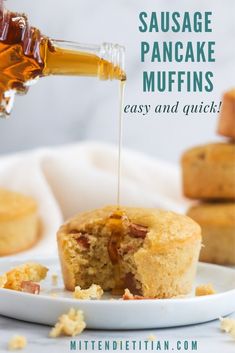 a person pouring syrup over a muffin on a plate