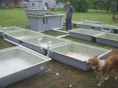 a man and his dog are standing in front of several empty tubs on the ground