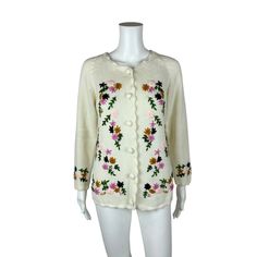 "Vintage 60s Floral Cardigan Embroidered Cream Multi Color Acrylic Sweater LABEL: Glamour Knits Fully Fashioned, Made in Taiwan FABRIC: 100% Acrylic MARKED VINTAGE SIZE: - SLEEVE LENGTH: 17\" underarm to end of sleeve BUST: 40\" WAIST: 38\" LENGTH: 24\" CONDITION: great, see photos- green thread popping out on back, loop sticking out of hem, loose purple thread on front PINNED TO MODEL?: no ☝For reference Mod's measurements are S 11\", B 32.5\", W 24\", H 32.5\"☝ ♪ Wanna dress you up in vintage, all over, all over! ♪ https://www.etsy.com/shop/StorylandVintage Ps. Follow @StorylandVintage on IG for sneaky peeks at vintage before it hits the shop!" Retro Crew Neck Cardigan For Spring, Vintage Crew Neck Outerwear For Spring, Spring Embroidered Crew Neck Outerwear, Retro Embroidered Sweater For Fall, Embroidered Cream Cardigan For Winter, Winter Cardigan With Floral Embroidery And Crew Neck, Retro Embroidered Fall Sweater, Vintage Embroidered Cardigan For Fall, Vintage Embroidered Sweater For Winter