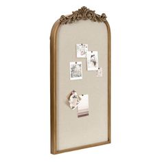 a wooden frame with pictures and magnets on it