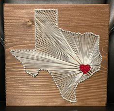 the texas state is made out of string and wood with a red heart on it