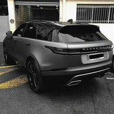 the range rover is parked in front of a garage with its door open and it's hood up