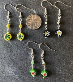 Dinky little handmade earrings, made from hexagon shaped millefiori glass beads, topped with matching millefiori floral beads. These are really pretty earrings, and, as with all of my designs, I never repeat a pair exactly, so you can be sure of a completely unique gift or treat. Perfect for dressing up or down, these earrings are sure to get noticed, due to their quirky design. Sterling silver earwires. Made with love in Kidwelly, Wales. Nickel-free Czech Glass Flower Earrings, Flower-shaped Beaded Czech Glass Earrings, Czech Glass Flower Earrings With Flower Charm, Flower Charm Round Bead Earrings For Gifts, Flower Charm Earrings With Czech Glass For Gift, Flower Charm Earrings With Round Beads As A Gift, Czech Glass Earrings With Flower Charm For Gift, Gift Earrings With Flower Charm And Czech Glass, Flower Charm Earrings With Round Beads For Gift