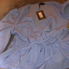 Pretty Little Thing Long Sleeves Blue Blouse In Us Size 16. It Has An Adjustable Waist And Elastic At The End Of The Sleeves. Material Is A 100% Polyester Aprox Measurements Laying Flat Pit To Pit 23 1/2” Length From Neck To Hem 26 1/2” Waist. 24” (Adjustable) 24”Would Be The Max Without Adjustment Sleeves Length 27 1/2” Smoke Free Home Elegant Blue Blouse For Brunch, Trendy Light Blue V-neck Blouse, Blue V-neck Blouse For Brunch, Light Blue V-neck Blouse For Day Out, Elegant Blue Blouse For Day Out, Blue V-neck Blouse For Day Out, Light Blue Long Sleeve Blouse For Brunch, Light Blue Long Sleeve Blouse For Day Out, Light Blue Casual Blouse For Party