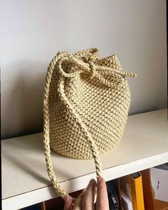 The Lucia Bucket Bag - Made to order 🤎Order directly from the atelier - www.atelierkris.co.uk Delicately hand crocheted bucket bag made from natural Raffia, The Lucia bag is a timeless creation. This bucket bag is a stylish and practical compact size, perfect for storing your daily essentials.  The design features a drawstring closure while offering incredible versatility to its design, by removing the drawstring Lucia can be also worn as a basket bag. Lucia's natural colour allows it to style in different ways, depending on your outfit and mood. Wear Lucia as a shoulder bag or crossbody bag. A bag design that is suitable not only for the summer months!  Colour: Light Beige (More colours available) Approx Size:  Height:  23cm  Diameter: 16cm Strap drop: 38cm Handcrafted from 100% biodegra Bucket Bag Crochet, Raffia Bucket Bag, Crochet Bucket Bag, Crochet Bucket, Raffia Bag, Colour Light, Handmade Bag, Bag Crochet, Basket Bag