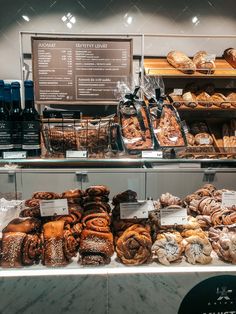 breads and pastries on display in a bakery