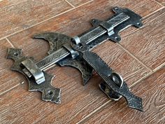 an old style metal latch on a wooden floor