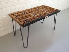 a table with many compartments on it and some hairpins in the tray underneath