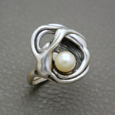 Showcase your love for unique jewelry with this stunning Modernist Design Sterling Silver Ring, featuring a natural cultured saltwater pearl. The abstract and expressive design of this piece makes it a standout addition to any jewelry collection. This high-quality, artisan handcrafted ring originates from the 1970s to 1980s era, showcasing the creative vibrant aesthetic of its time. It will be shipped in a gift box and makes for a thoughtful gift! Ring size: US: 8 1/4, UK: Q 1/2, European size: Pearl Vintage, Talented People, Modernist Jewelry, Saltwater Pearls, Modernist Design, Window Shopping, Handcrafted Rings, Hand Crafted Jewelry, Design Jewelry