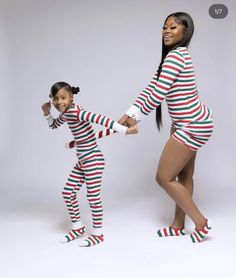 two women in matching christmas pajamas holding hands