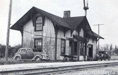 an old train station with a car parked next to it