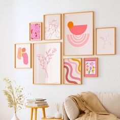 a living room filled with furniture and pictures on the wall above it's coffee table