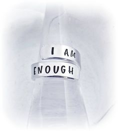 Remind yourself or someone you love I AM ENOUGH with this high shine hand stamped wrap ring! The hypoallergenic grade metal will never tarnish and is made to last a lifetime. If you would like a different quote or different font, please leave a note during checkout including the customization you'd like. Although these rings are adjustable, please choose your ring size from the drop down menu for the best fit. Please keep in mind the position of the words will depend on the size you order. The r Inspirational Jewelry Quotes, Spiral Ring, Inspirational Jewelry, I Am Enough, Different Quotes, Wrap Ring, Different Fonts, Custom Ring, Ring Pictures