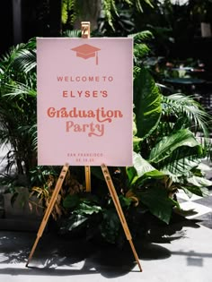 a welcome sign for elye's graduation party in front of some plants and trees