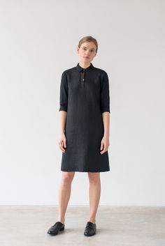 "An oversized fit dress with three-quarter length sleeves, a subtle back pleat, rounded collar and partial button fastening. -  Shirt collar with rounded points -  Set-in 3/4 sleeves closes with wide cuffs -  Partial button fastening -  Bust darts -  Inverted back pleat -  Straight hemline -  Knee length -  Unlined Ready to ship. Material & manufacturing Made in Lithuania from local medium weight 100% Oeko-Tex certified linen fabric and mother of pearl buttons.   Color - black  *Due to the unique properties of linen and its manufacturing process, the colors between batches can change slightly. Size & fit View size guide in the last picture. Model is 176cm (5'9\") tall and is wearing a XS. Length from shoulder  S   - 99cm / 39\" If you're not sure about a product's size, we would be glad to Relaxed Fit Half Sleeve Work Dresses, Elegant Linen Dress With 3/4 Sleeves, Black Linen Dress For Summer Workwear, Black Linen Dress For Workwear In Summer, Linen Half Sleeve Dress With Relaxed Fit, Daywear Linen Dress With 3/4 Sleeves, Linen Dress With 3/4 Sleeves For Daywear, Black Linen Dresses For Fall, Black Linen Long Sleeve Dress