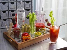 a tray filled with different types of food and drinks on top of a table next to a window