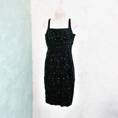 50's heavily beaded black wiggle dress. It is form fitting and sleeveless with a scoop neckline. Truly an old Hollywood style beauty. Please note it is very narrow at the hem. I could not fit it over my size 4 dress form. So I have listed the measurements around the bottom of the skirt. It zips up the back and is fully lined. Size Small Measurements with room for comfort: Bust up to: 35 inches. Waist up to: 26 inches. Hips up to: 35 inches Measurement around at the hem is 32 inches. Exact measur Vintage Black Embellished Dress, Black Beaded Vintage Dress, 1950s Fitted Black Dress, Vintage Beaded Dresses For Night Out, Vintage Fitted Sequin Dress, Fitted Vintage Sequin Dress, Vintage Sheath Dress For Party, 1950 Wedding Dress, Black Wiggle Dress