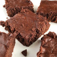 several pieces of chocolate brownie on a white plate