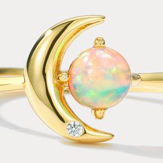 This exquisite Moon Star Opal Ring is the perfect statement piece for any occasion. Crafted from the highest quality materials and featuring a prominent opal centrepiece, this ring is sure to make you stand out from the crowd in style. An ideal gift for yourself or a loved one, it’s sure to become a cornerstone of your wardrobe. DETAILS Plating: 10K Gold Materials: 10K Gold on   Silver,   Cubic Zirconia,   Opal Size: Adjustable Weight: 1.4g Sun Ring Opal, Sun Ring With Opal, Luxury Celestial Opal Ring For Anniversary, Luxury White Opal Celestial Ring, Luxury Celestial Opal Ring, Star And Moon Necklace, Astrology Jewelry, Fire Opals Jewelry, Rabbit Earrings