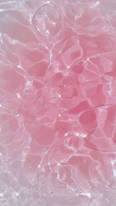 the water is pink in color and it looks like bubbles or waves are floating on top of each other