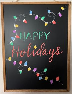 a chalkboard with the words happy holidays written in multicolored lights on it