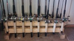 a bunch of fishing rods are lined up on a rack