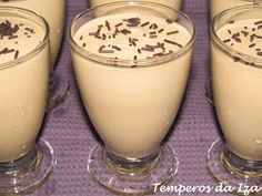 four glasses filled with milk and chocolate sprinkles